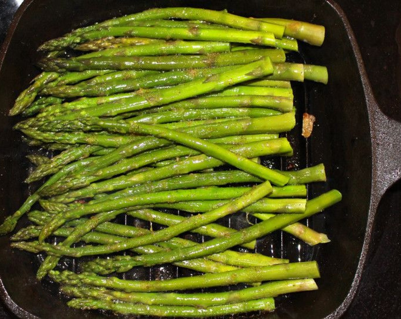 step 8 Repeat the seasoning with the asparagus. Coat in Peanut Oil (1 tsp), Kosher Salt (to taste), Cayenne Pepper (to taste), and Granulated Garlic (to taste), Grill asparagus until heated through and there are grill marks.